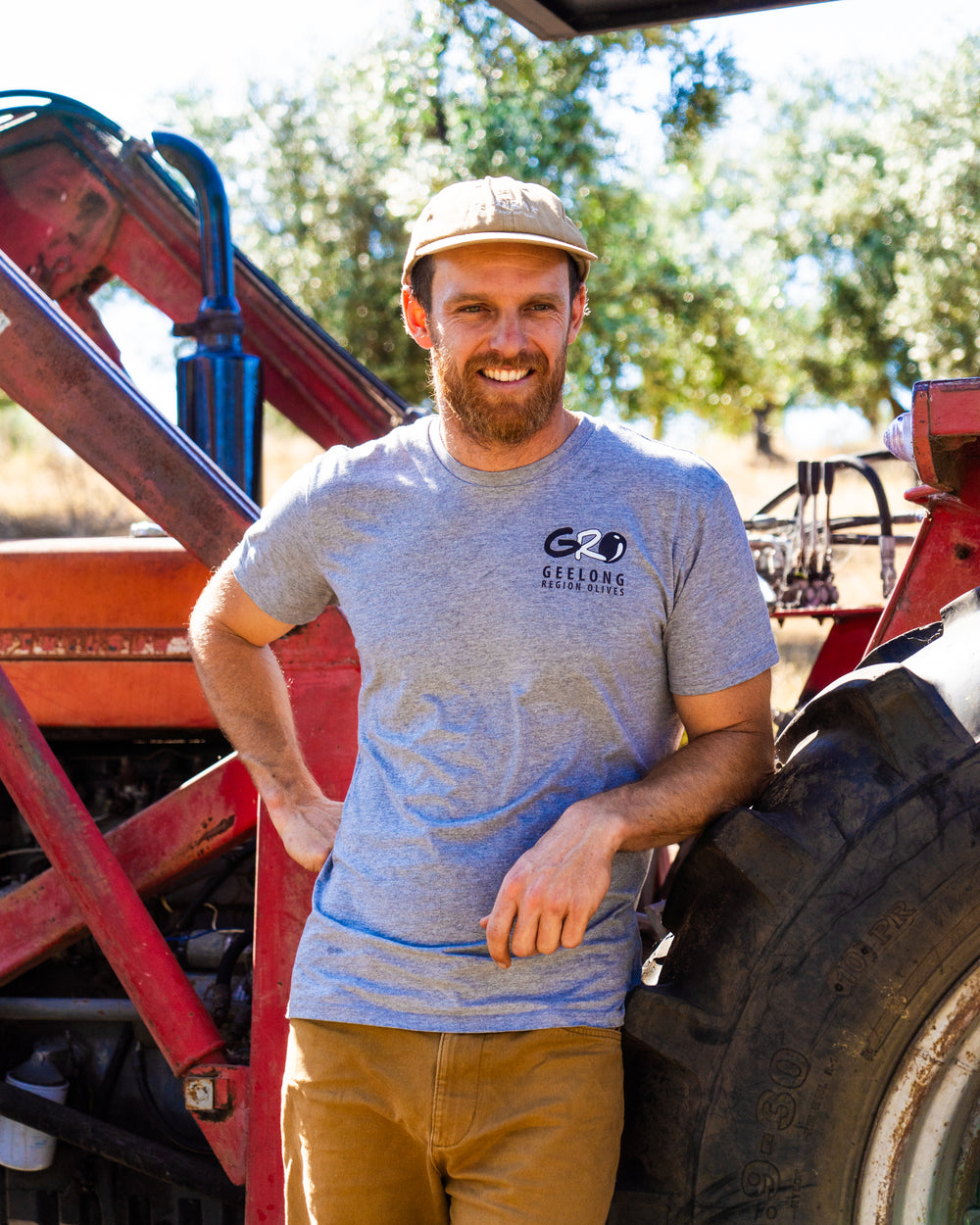Grower leaning on a tractor
